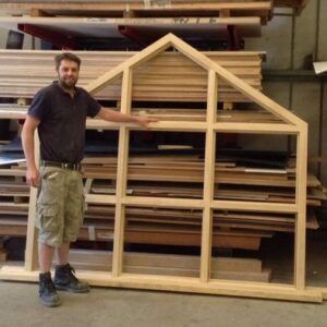 Man standing next to wood frame